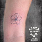 Minimalist fine line flower tattoo, created at Lanza Tattoo in Puerto del Carmen.