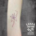 Fine line flower tattoo created at Lanza Tattoo in Puerto del Carmen.