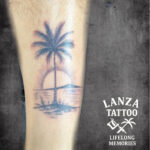 Black and grey palm tree sunset tattoo inspired by Lanzarote, created at Lanza Tattoo in Puerto del Carmen.
